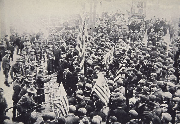 Armed troops confronting protesters during an industrial dispute, USA, 1912. Artist