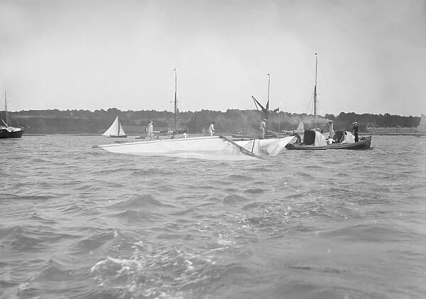 The dismasted sailing yacht Clio is attended to by rescue boats, 1912. Creator