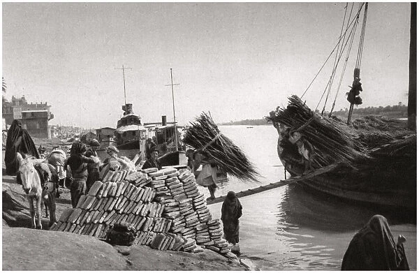 Unloading cargo from a boat, Muhaila, Baghdad, Iraq, 1925. Artist: A Kerim