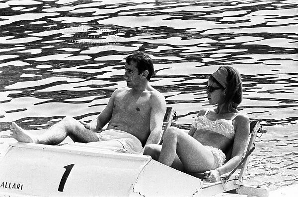 Monaco Grand Prix practice 1966. Jackie Stewart relaxes on a pedalo with his wife Helen