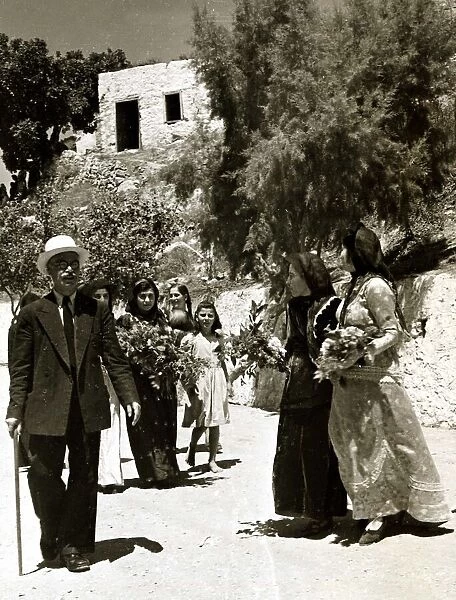 The women of Karpathos in traditional costume, great visitors with armfuls of flowers
