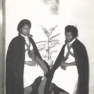 Two black student nurses sitting by a plant in the Womens H