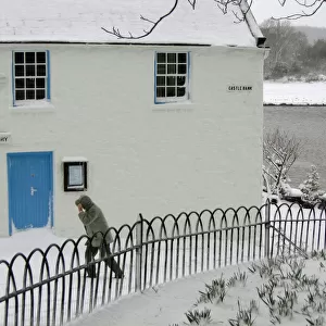 Man walks past the Harbour Cottage Gallery in Kirkcudbright