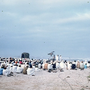 Omani Elders looking towards the sea on a beach in Oman