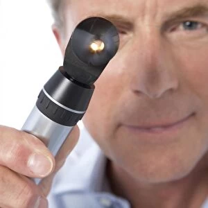 Doctor holding an otoscope