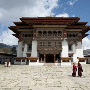 Buddhist monks in stone courtyard of Gangtey dzong (monastery), the largest Nyingmapa