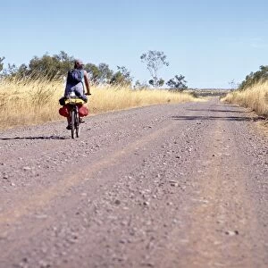Lone cyclist on country road, Western Australia, Australia, Pacific