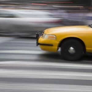 New York taxi cab driving fast over a pedestrian crossing, Manhattan, New York