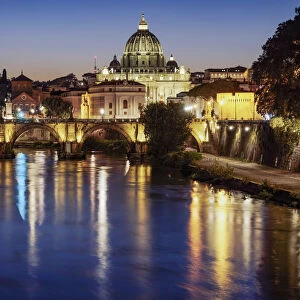 Night view of San Angelo Bridge on River Tiber with background of illuminated St. Peters Basilica in the Vatican, Rome, Lazio, Italy, Europe