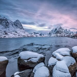 Picturesque sunrise in the Bay of Reine with the typical Norwegian rorbu, once home for the fisherman, now tourist accommodation, Lofoten Islands, Arctic, Norway, Scandinavia, Europe