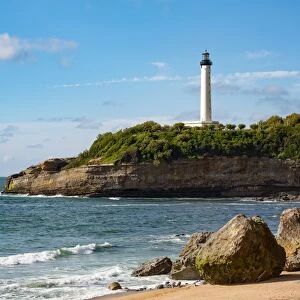 Rocks on the sandy beach and the lighthouse in Biarritz, Pyrenees Atlantiques, Aquitaine