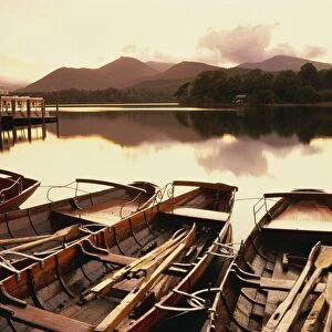 Tranquil scene at sunset over Derwentwater and Derwent Isle with pleasure boats