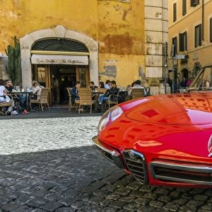 Alfa Romeo Duetto spider parked in a cobblestone street of Rome, Lazio, Italy