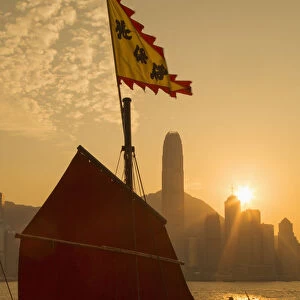 Sail of Aqua Luna junk boat and Central skyline at sunset, Hong Kong Island, Hong Kong