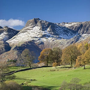 Snow dusted Langdale Pikes viewed from the shores of Loughrigg Tarn, Lake District