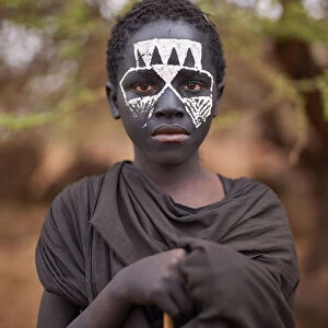 A young Msai warrior holding a stick in the Ngorongoro Protected Area, Tanzania