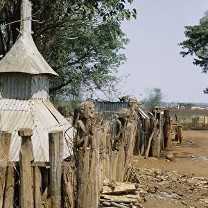 VIETNAM, Pleimrong Montagnard village graveyard with carved wooden figures on posts