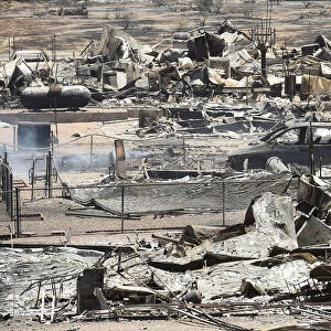 The remains of scorched homes line a street after the Erskine Fire burned through South