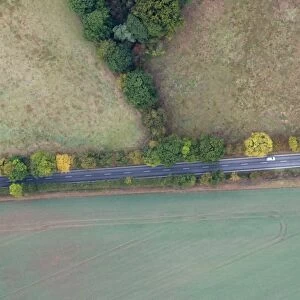 Aerial view of road cutting through countryside south of Norwich Norfolk