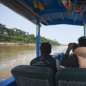 Birdwatching from a motorised canoe along the Tambopata River in the Peruvian Amazon