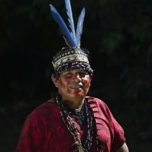 Shamans assistant from Bora Tribe wearing Macaw feather head dress Northern Amazon