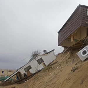Eroded sea cliffs and damaged chalets after December 2013 tidal surge, Hemsby, Norfolk, England, January