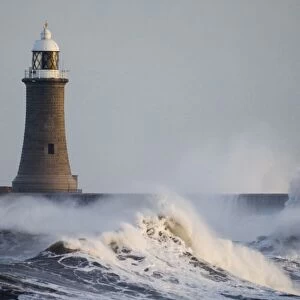 Rough sea and breakwater with lighthouse, Tynemouth Pier, Tynemouth, Tyne and Wear, England, winter