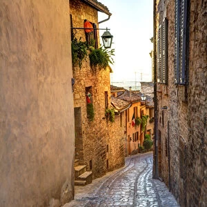 Europe; Italy; Umbria; Spello; Colored Buildins along a Back Street of Spello