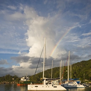 Seychelles, La Digue Island, La Passe, harbor at dusk with rainbow
