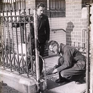 Workmen removing iron railings [1939-1945]