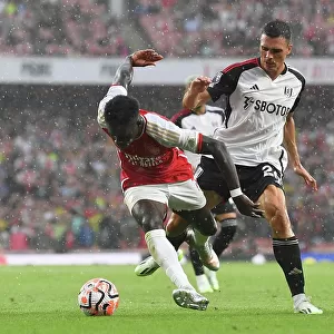 Arsenal's Bukayo Saka Fights for Possession Against Fulham's Joao Palhinha in 2023-24 Premier League Clash