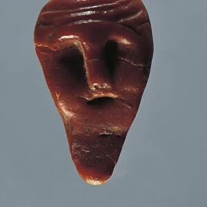 Amber head from Asarps, Sweden
