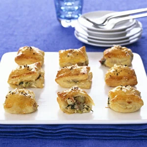 Artichoke puff pastry bites served on square plate