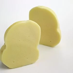 Two pear-shaped slices of Italian Scamorza cows milk cheese