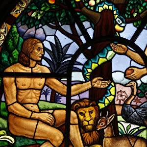 Stained glass window depicting Adam and Eve in the Garden of Eden