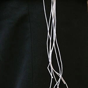 Tallit Katan (small talit or taleth) threads over suit