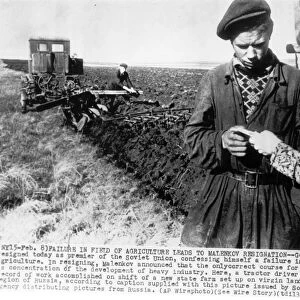 A tractor driver and clerk checking the record of work accomplished on a shift of a new state farm set up on virgin land in the chkalov region of russia, 1955
