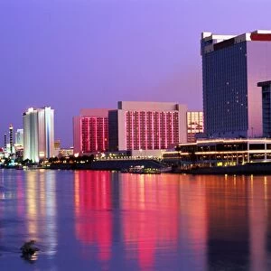USA, Nevada, Las Vegas, Casino Row, floodlit buildings reflcted in water at night
