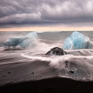 Ice on the black volcanic sand beach in summer in Iceland