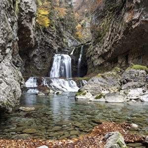 Waterfall in a forest in the Pyrenees in autumn