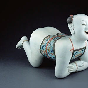 A Chinese porcelain pillow in the form of a semi-naked boy (porcelain)