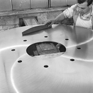 A machinist quality checking a six foot circular saw blade, Sheffield, South Yorkshire, 1963