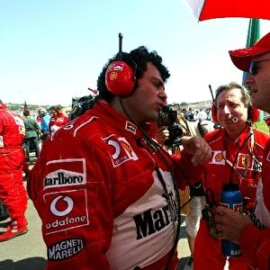 Formula One World Championship: Gabriele Delli Colli Ferrari Race Engineer talks with Rubens Barrichello Ferrari on the grid watched by Jean