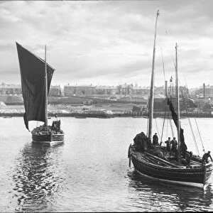 Magic lantern slide circa 1880, Victorian / Edwardian Social History. Two fishing boats leaving harbour with South Shields town in the background. Fishermen can be seen on their sail fishing boats preparing for sea; South Shields, Tyne and Wear, England