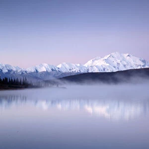 Scenic view of Mount Denali and the Alaska Range while morning mist rises from Wonder Lake