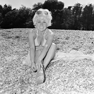 Barbara Windsor, Actress, 7th July 1976. Pictured, taking a break from an unusual role