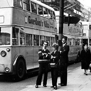 A good time for a chat when trolley bus drivers and a conductress take a break as