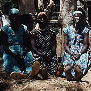 Luo women smoking traditional pipes Nyanza Province South West Kenya Africa