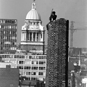 Man demolishes a chimney tower by mallet in London October 1970