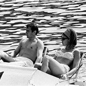Monaco Grand Prix practice 1966. Jackie Stewart relaxes on a pedalo with his wife Helen